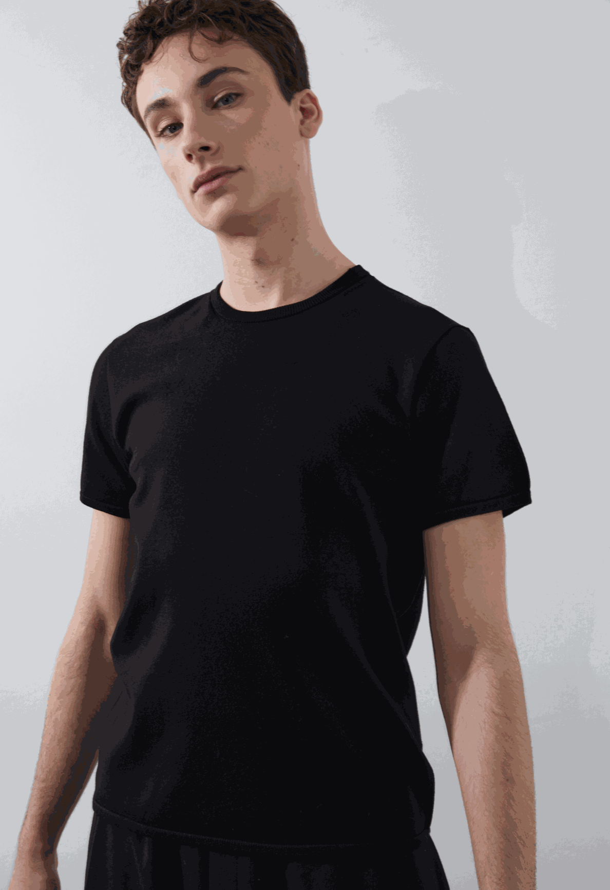 Beckett Tee in black, tailored fit, model wearing size medium.