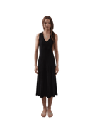 Jaci Dress in black, sleeveless V-neckline, A-line flare, pleated knit texture, eco-friendly fabric, modeled by Jade.